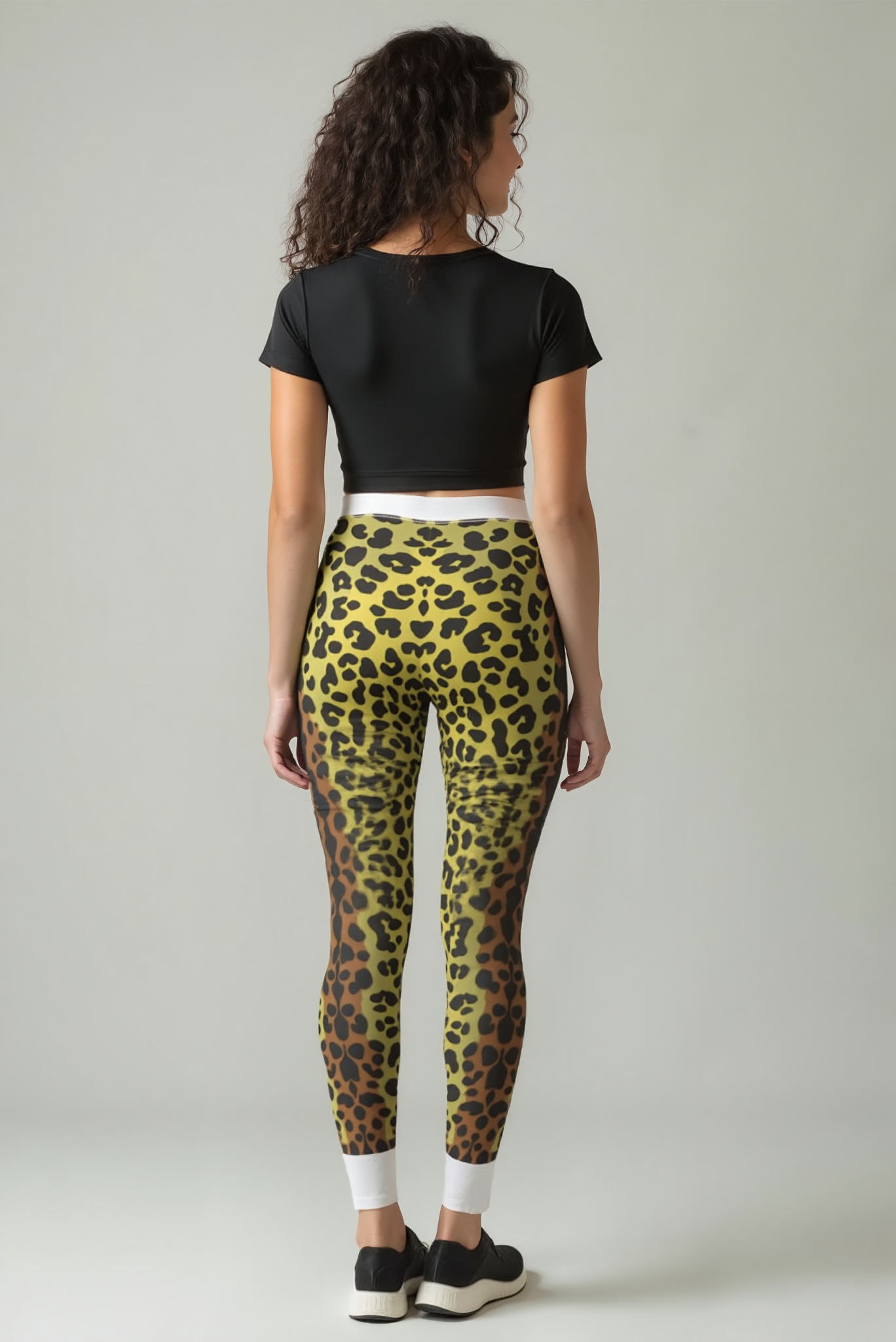 Back view of a model in Fierce Leopard Print Leggings for Women that accentuate the design's unique leopard print. Ideal for gym workouts, these high-waist and seamless leggings ensure comfort with amazing 4-way stretch, making them perfect as compression leggings and stylish athleisure wear.