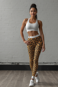 A model showcasing Wild Leopard Print Casual Leggings, designed for women looking for stylish activewear. These statement leggings are high-waist, squat-proof, and perfect for both fitness and loungewear. The seamless, 4-way stretch design ensures maximum comfort and support, making them ideal gym leggings and athleisure leggings.