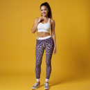 Confident woman wearing Purple Leopard Print Casual Leggings, showcasing their stunning designer style, these gym leggings are crafted as high-waist, squat-proof, and 4-way stretch leggings, perfect for any active lifestyle.