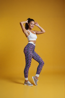 Chic model posing in Purple Leopard Print Casual Leggings, ideal for both workouts and casual outings, designed as sport-luxe leggings with seamless and compression features for a flattering fit, great for athleisure wear.