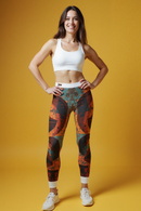 A woman confidently modeling Bohemian Printed Leggings against a bright yellow background, perfect for yoga, workout, or casual style.