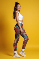 A side profile of a confident woman wearing stylish abstract print leggings for women, designed for versatility in yoga and athleisure. Featuring compression qualities, these high-waist leggings are ideal as sport-luxe leggings, combining fashion and function seamlessly.