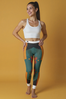 A model wearing stylish women's casual leggings, AOP print activewear, smiles confidently. These sport-luxe leggings combine a beautiful design with practical features, including a high-waist silhouette and the flexibility of 4-way stretch. Perfect for any workout or relaxed day out.