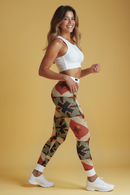 A model walks confidently in trendy printed leggings, embodying a blend of fashion and function. Designed by a renowned designer, these high-waist leggings are squat-proof and made from compression materials that offer 4-way stretch. The statement leggings are suitable for workouts and casual outings alike, defining them as stylish athleisure pieces. Their seamless design provides an unmatched fit, perfect for those seeking style and comfort in their gym leggings.
