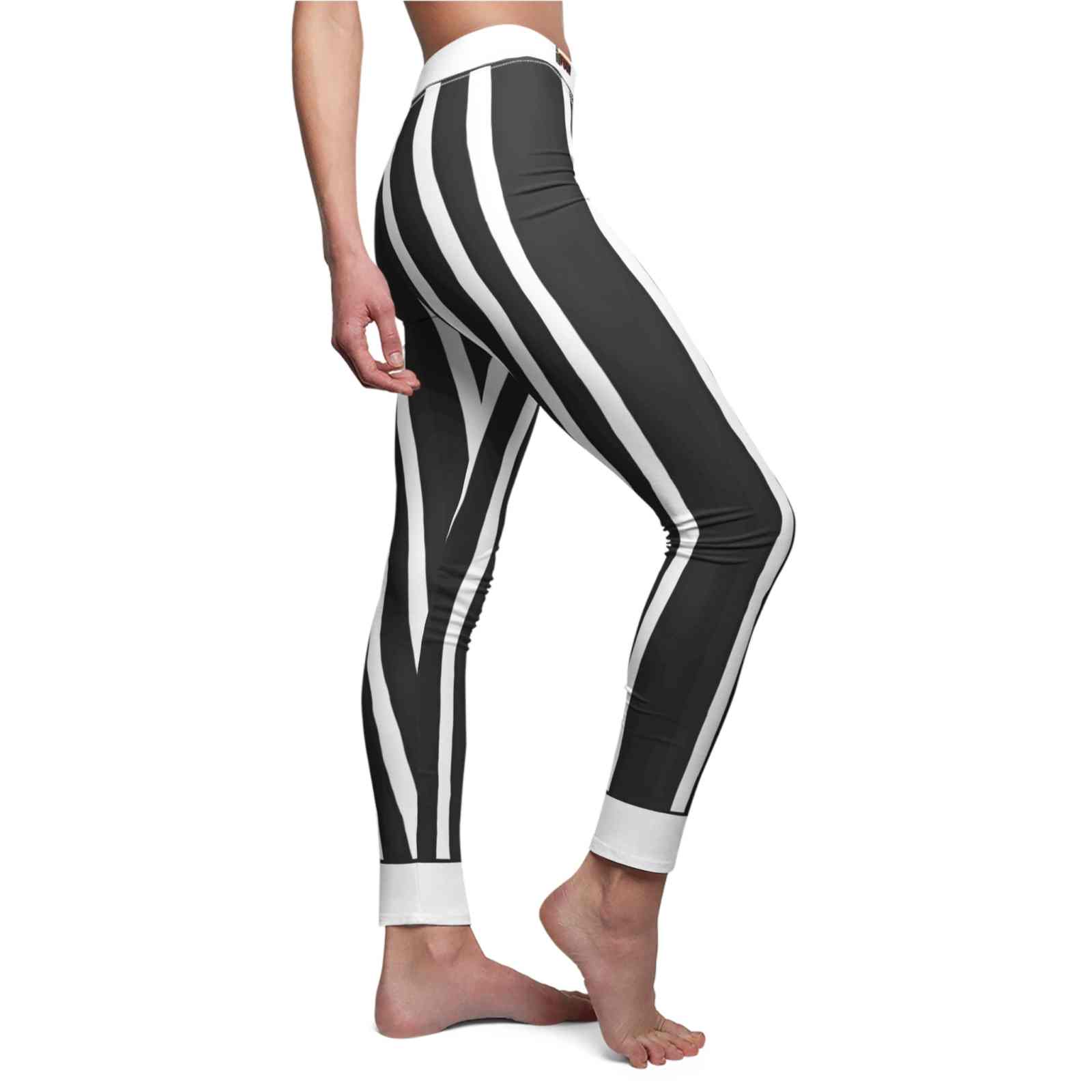 Side view of Chic Striped Casual Leggings for Women, highlighting the sleek fit and stylish black and white stripes. These high-waist leggings are designed for ultimate comfort and movement, crafted from breathable fabrics that ensure they are squat-proof and provide 4-way stretch. Perfect for athleisure wear or to elevate your gym outfit, these designer leggings are essential sport-luxe essentials that combine fashion and functionality seamlessly.