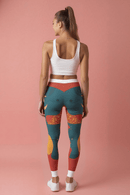 Vibrant Women's Casual Leggings - Bold Art Print, Yoga, Workout, Lounge, Gift for Her - model displaying the back view of leggings with artistic patterns on a pink background.