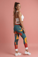 Vibrant Women's Casual Leggings - Bold Art Print, Yoga, Workout, Lounge, Gift for Her - model showcasing leggings with colorful abstract design on a pink background.